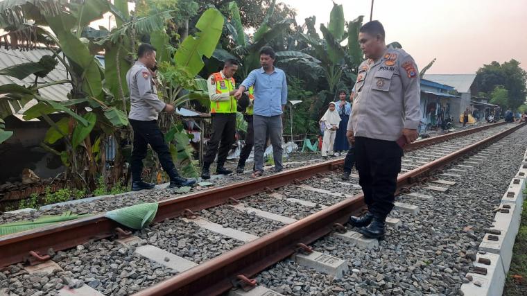 Polisi saat mendatangi lokasi tiga orang tewas dan satu kritis tertabrak kereta api. (Foto: TitikNOL)